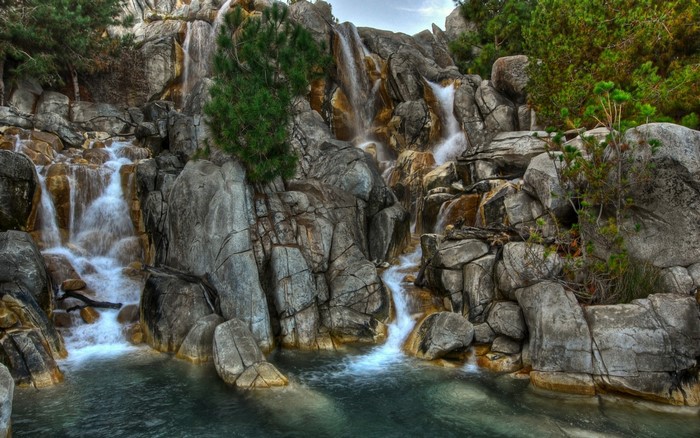 Waterfall cascading over rocks into a pool