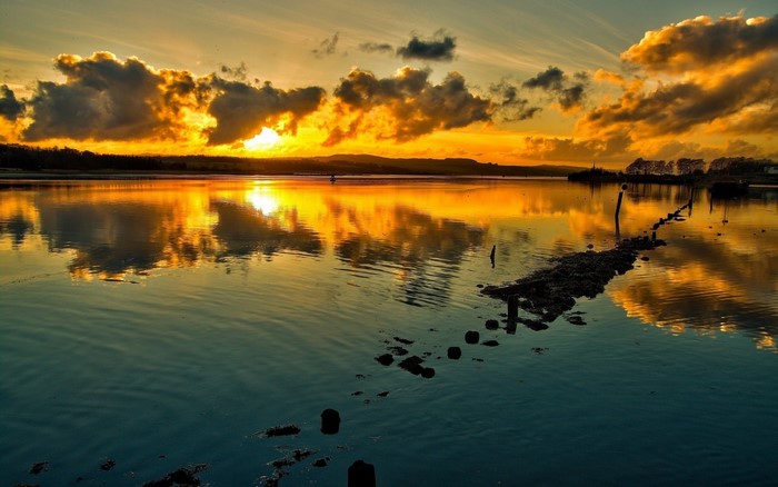 Sunset over a calm lake with reflections