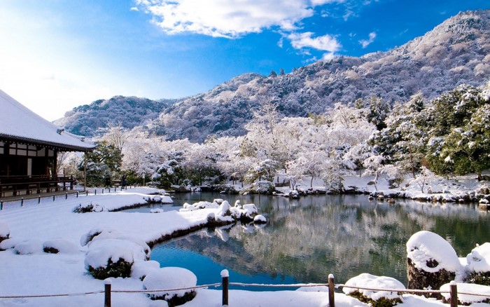 Snowy Japanese Garden with Temple and Mountain