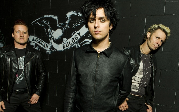 Green Day band members in front of American Eulogy mural