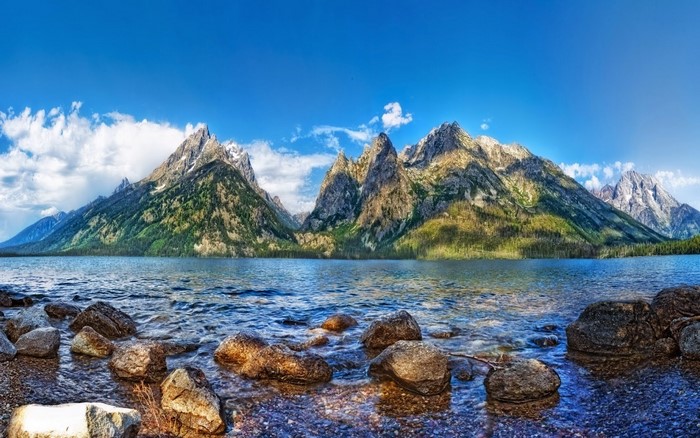 Panorama of Grand Teton National Park mountains and lake