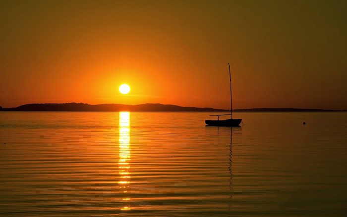 Sailboat on the water at sunset