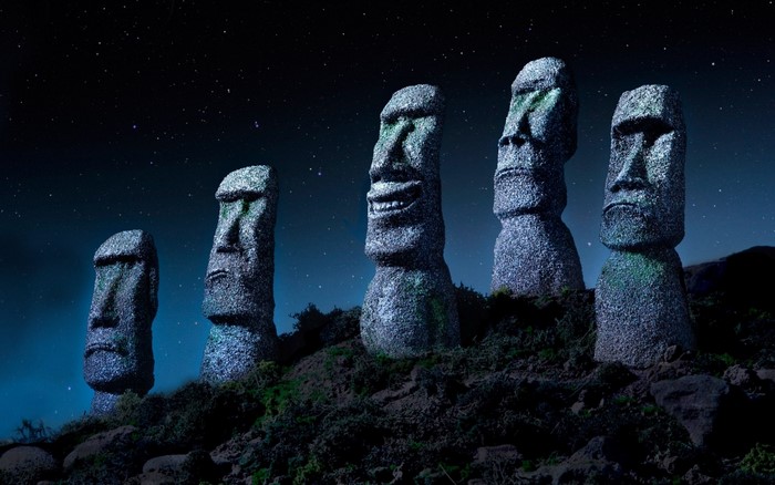 Moai statues on Easter Island at night under starry sky