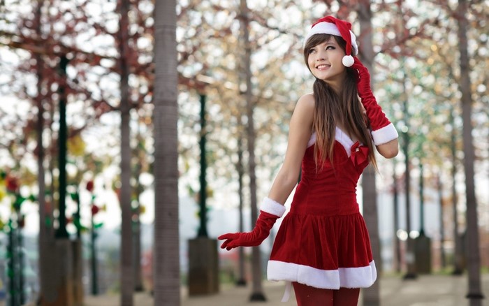 Woman in Santa Costume Posing in a Forest