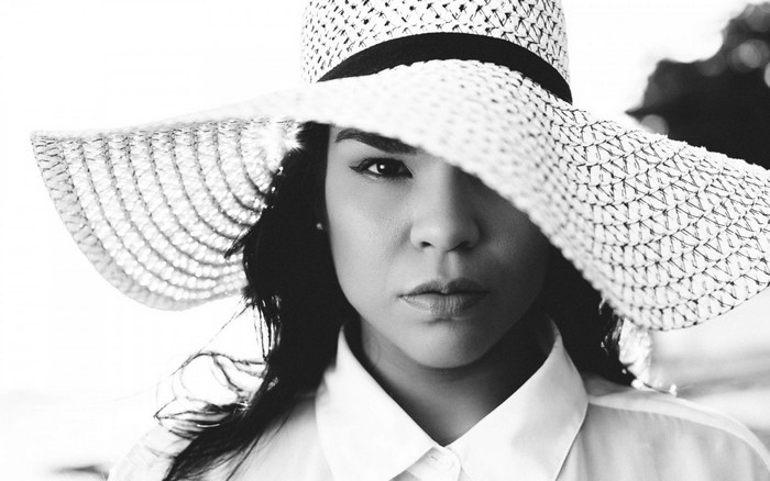 Woman wearing a wide-brimmed hat and white shirt