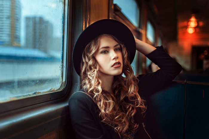 Woman in hat on a train