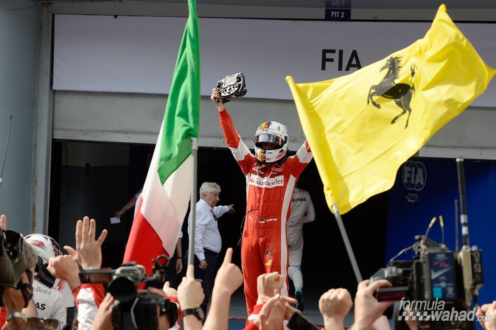 Sebastian Vettel celebrates with Ferrari flags