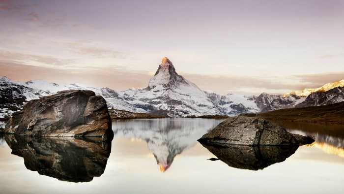 Matterhorn mountain reflected in a lake with rocks