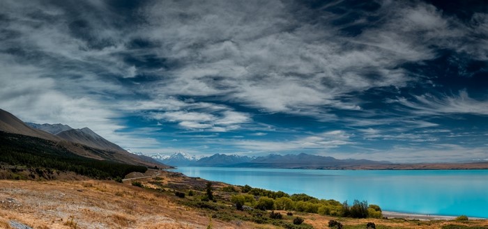Turquoise lake and mountains under a cloudy sky