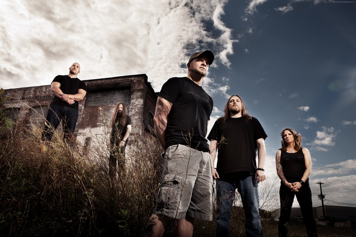 All That Remains band members in front of a building
