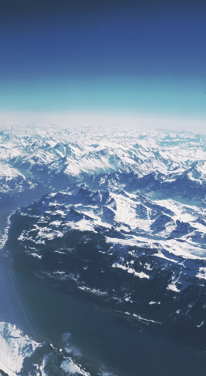 Aerial view of snow-covered mountains and sky