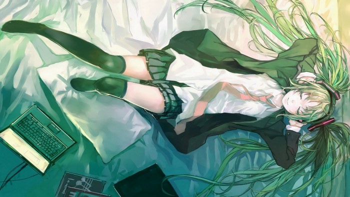 Hatsune Miku from Vocaloid lying on a bed with a laptop