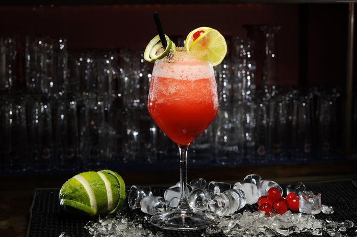 Daiquiri cocktail with lime and cherry garnish