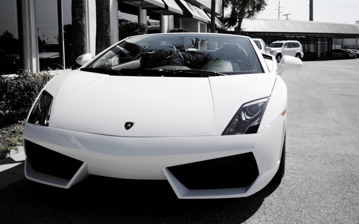 White Lamborghini Gallardo parked outside building