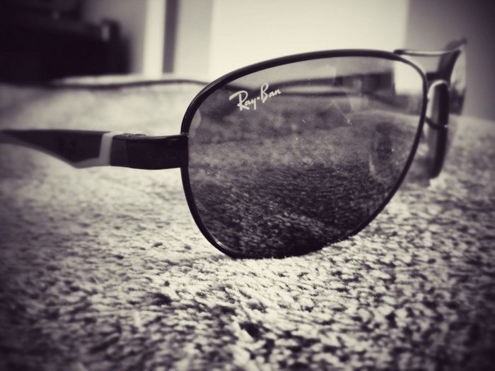 Ray-Ban sunglasses on a textured surface