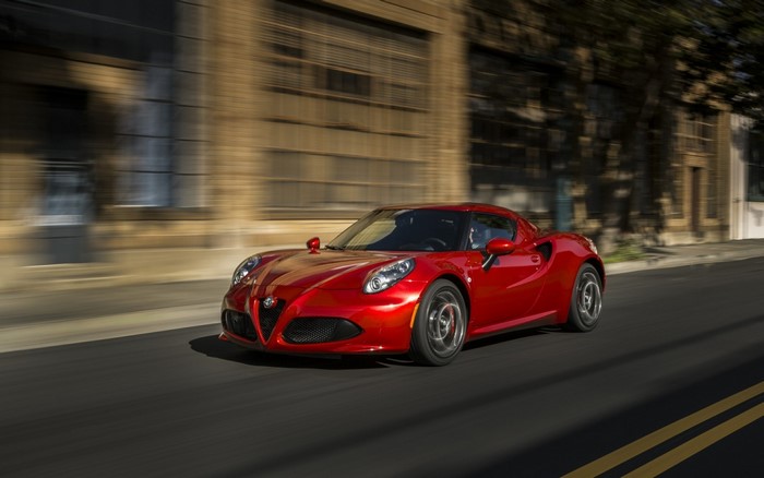 Red Alfa Romeo 4C driving on a street