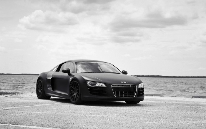 Matte black Audi R8 sports car by the water