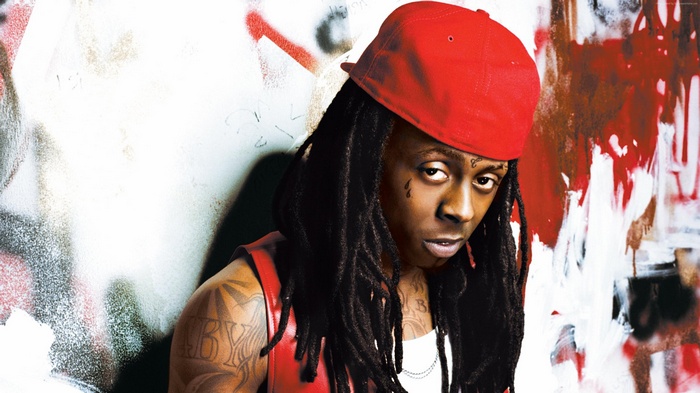 Lil Wayne wearing a red cap and vest