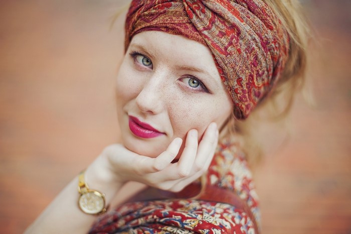 Portrait of Smiling Woman with Red Scarf and Freckles