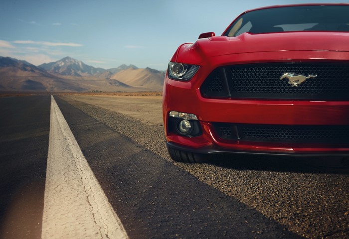 Red Ford Mustang on a desert road