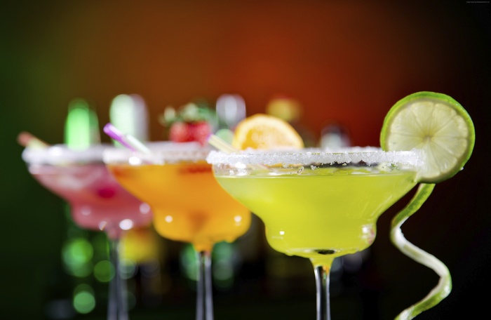 Cocktails with fruit garnishes on a bar