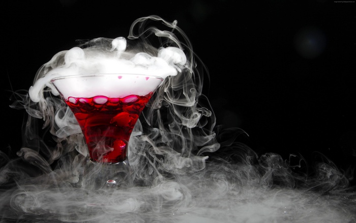 Red cocktail with dry ice and smoke