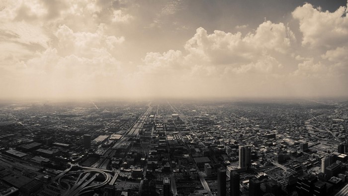 Aerial view of a sprawling city under a cloudy sky