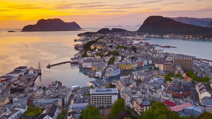 Alesund, Norway cityscape at sunset with mountains and sea