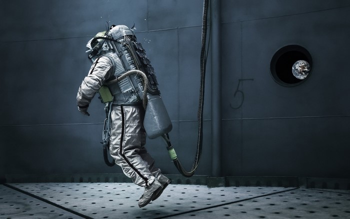 Astronaut floating in a dark room with Earth visible through a window
