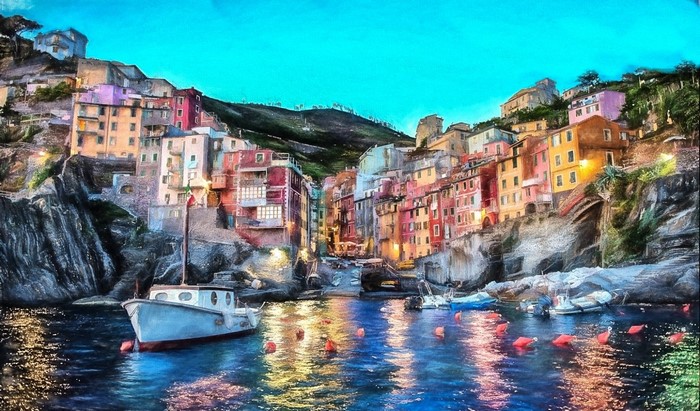 Colorful village on a cliffside overlooking a harbor with boats