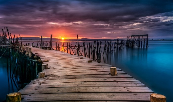 Wooden pier at sunset over the sea