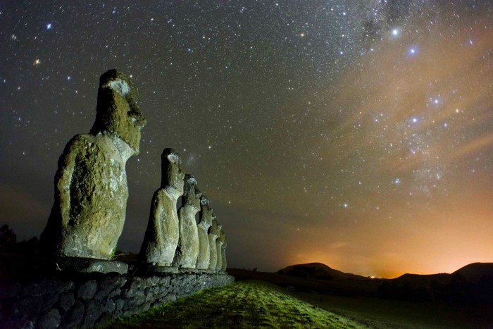 Moai statues under a starry night sky on Easter Island