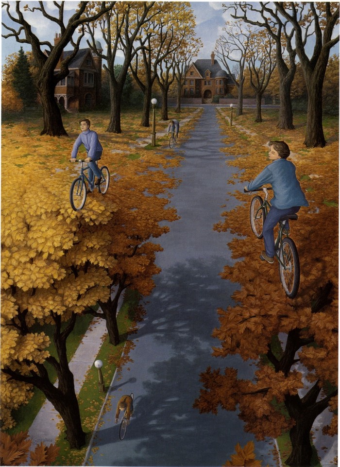Children cycling on a tree-lined path in autumn