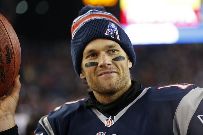Tom Brady of the New England Patriots holding a football