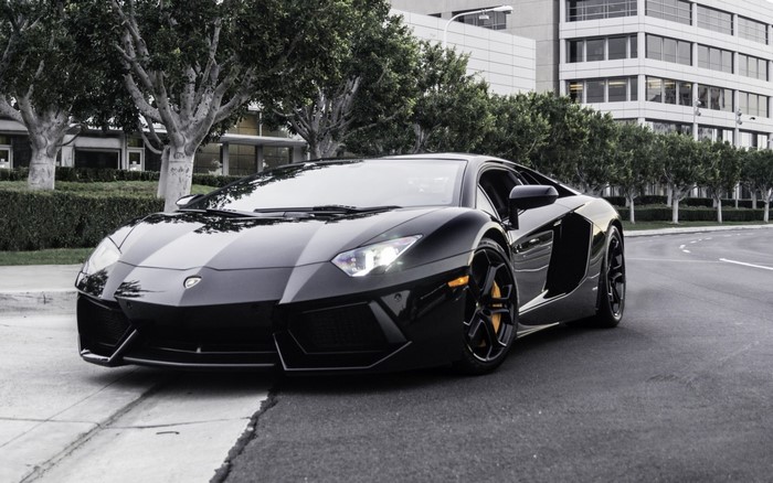 Black Lamborghini Aventador parked on a street