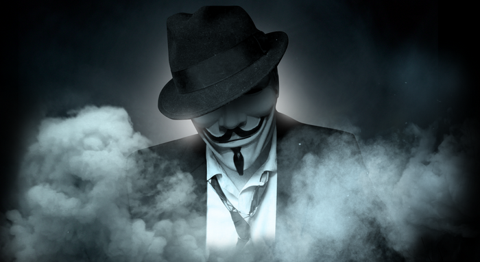 Man in Anonymous mask and fedora hat