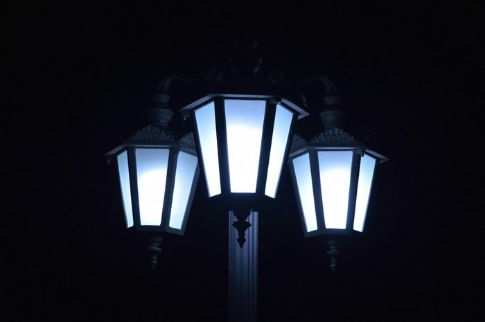 Triple lantern street light at night