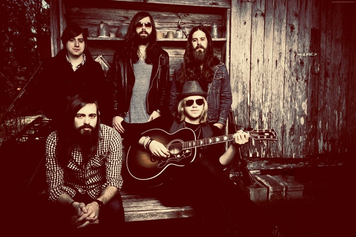 A Thousand Horses band members with guitar