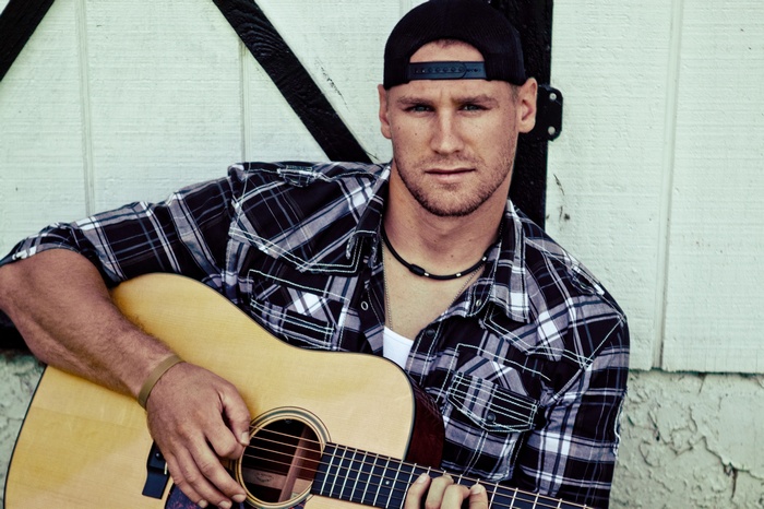 Chase Rice playing acoustic guitar