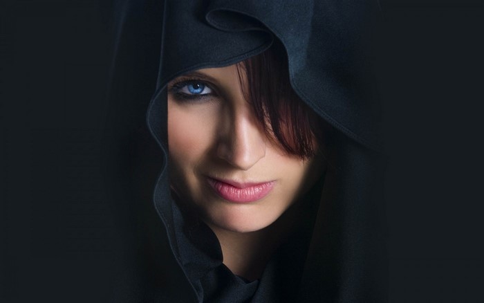 Woman with blue eyes wearing a black hood
