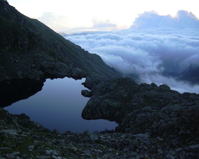 Mountain lake above the clouds at dusk