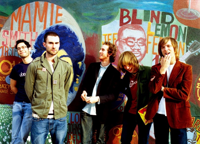 Maroon 5 band members in front of a mural