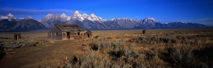 Abandoned cabin in front of the Teton mountain range