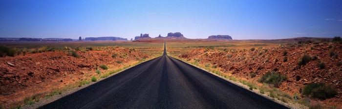Road through Monument Valley desert landscape