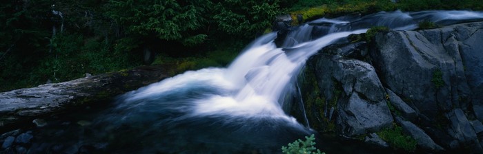 Waterfall flowing over rocks in a forest