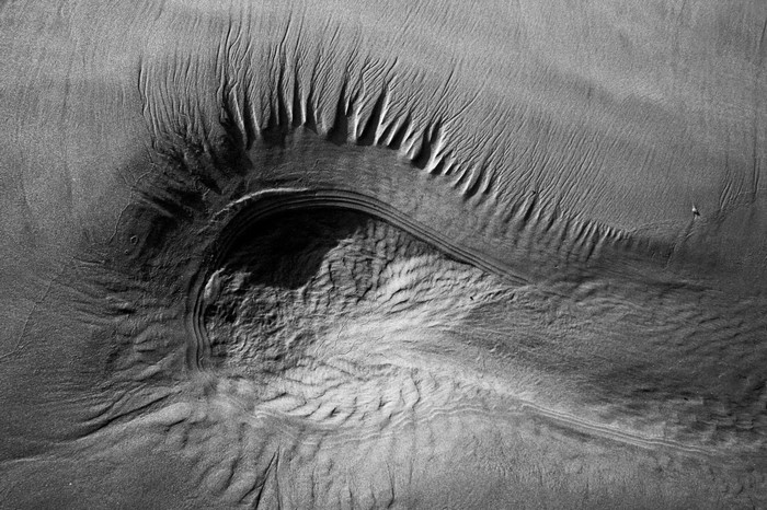 Monochrome sand patterns resembling an eye
