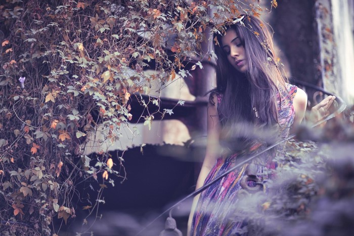 Woman in a colorful dress among autumn foliage