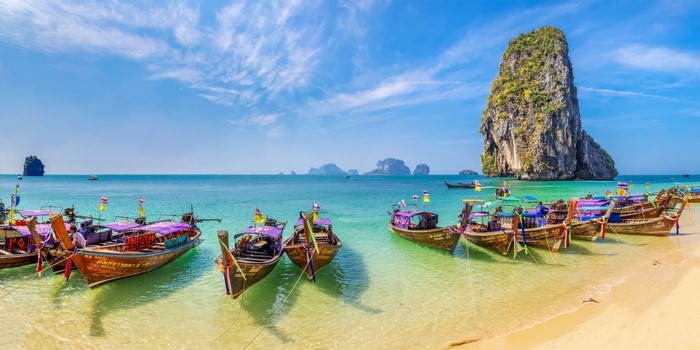 Long tail boats on a tropical beach in Thailand
