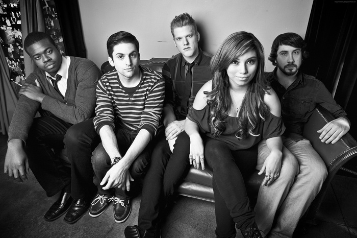 Pentatonix band members sitting on a couch
