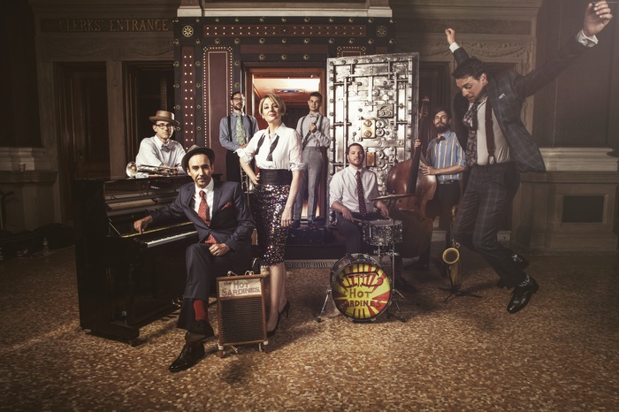 The Hot Sardines band performing in front of a vault